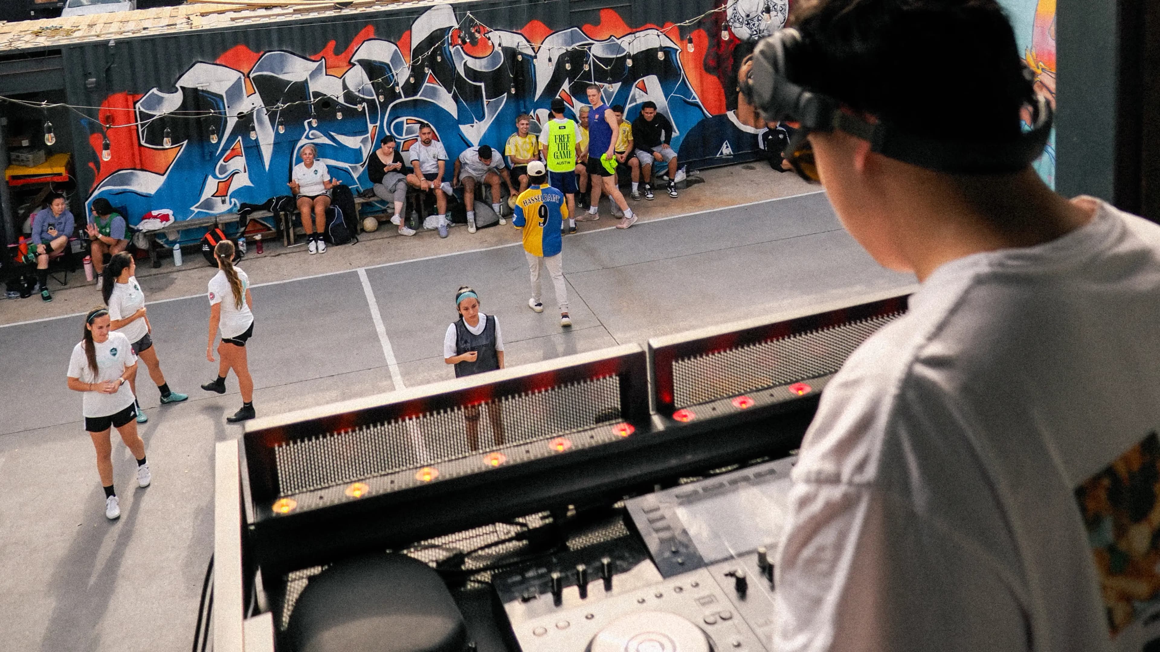 DJ on the decks overlooking the East-side court