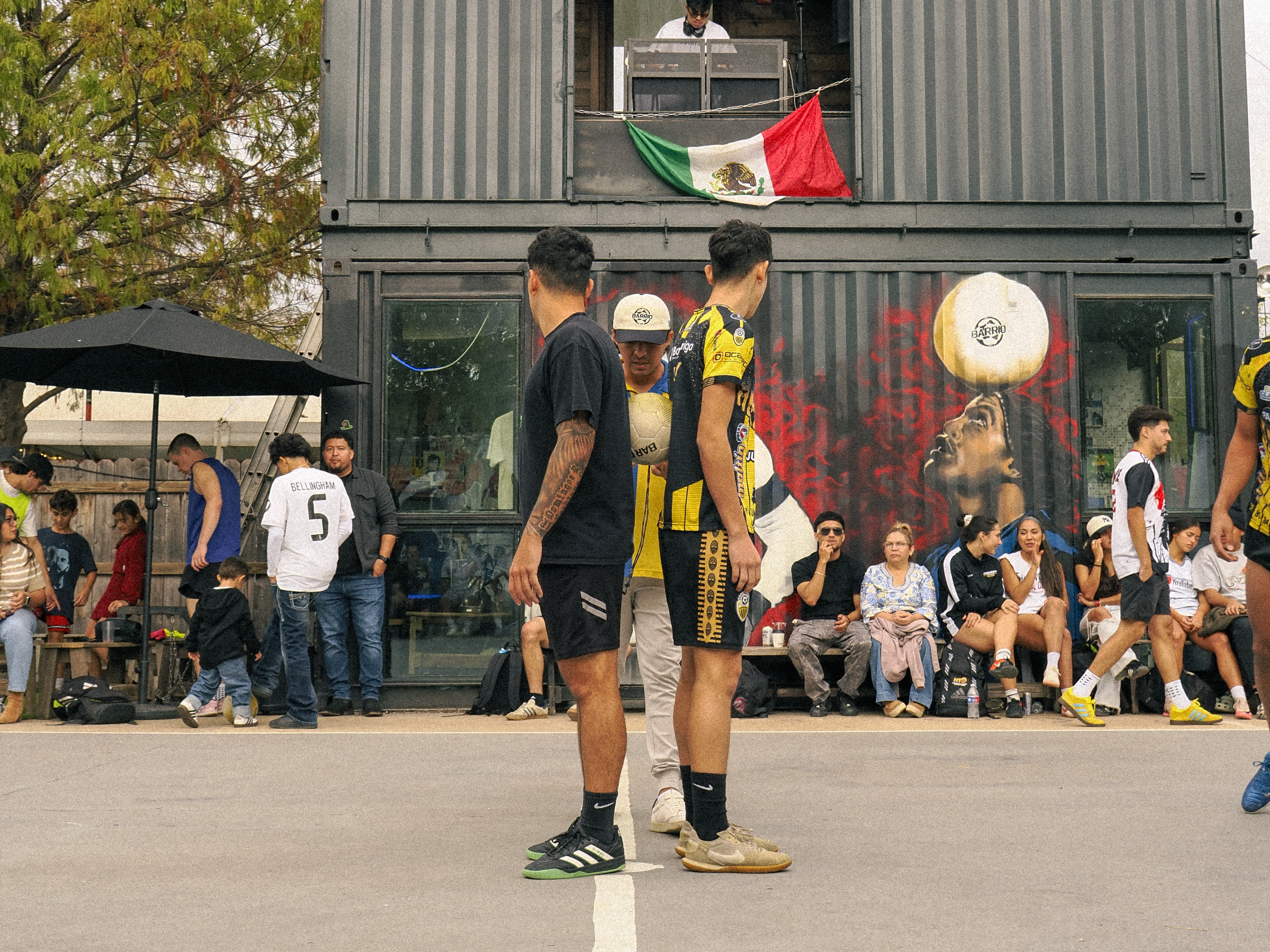 Two players in front of an East-Austin mural
