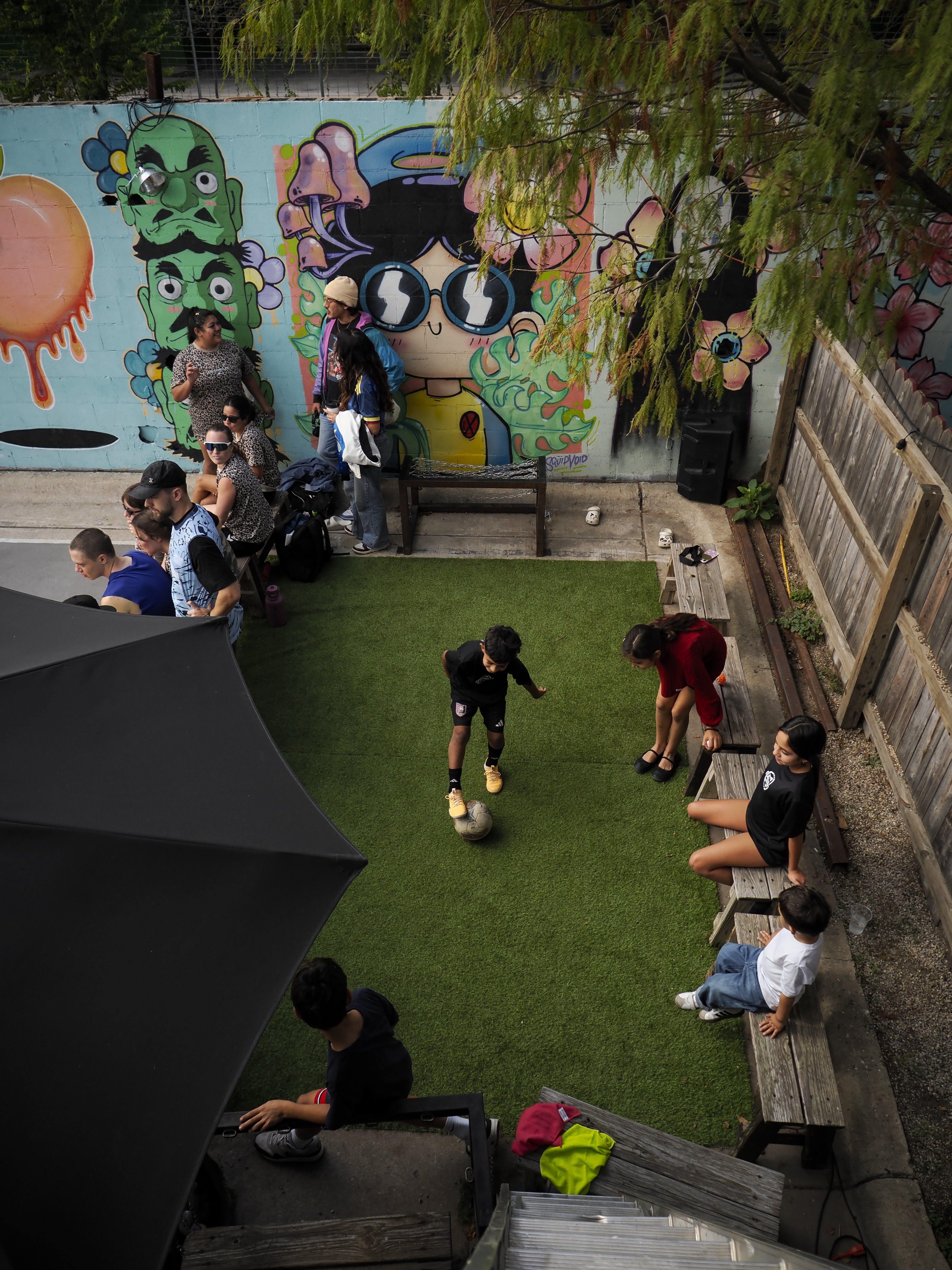 Players and neighbors around the East-side futsal court