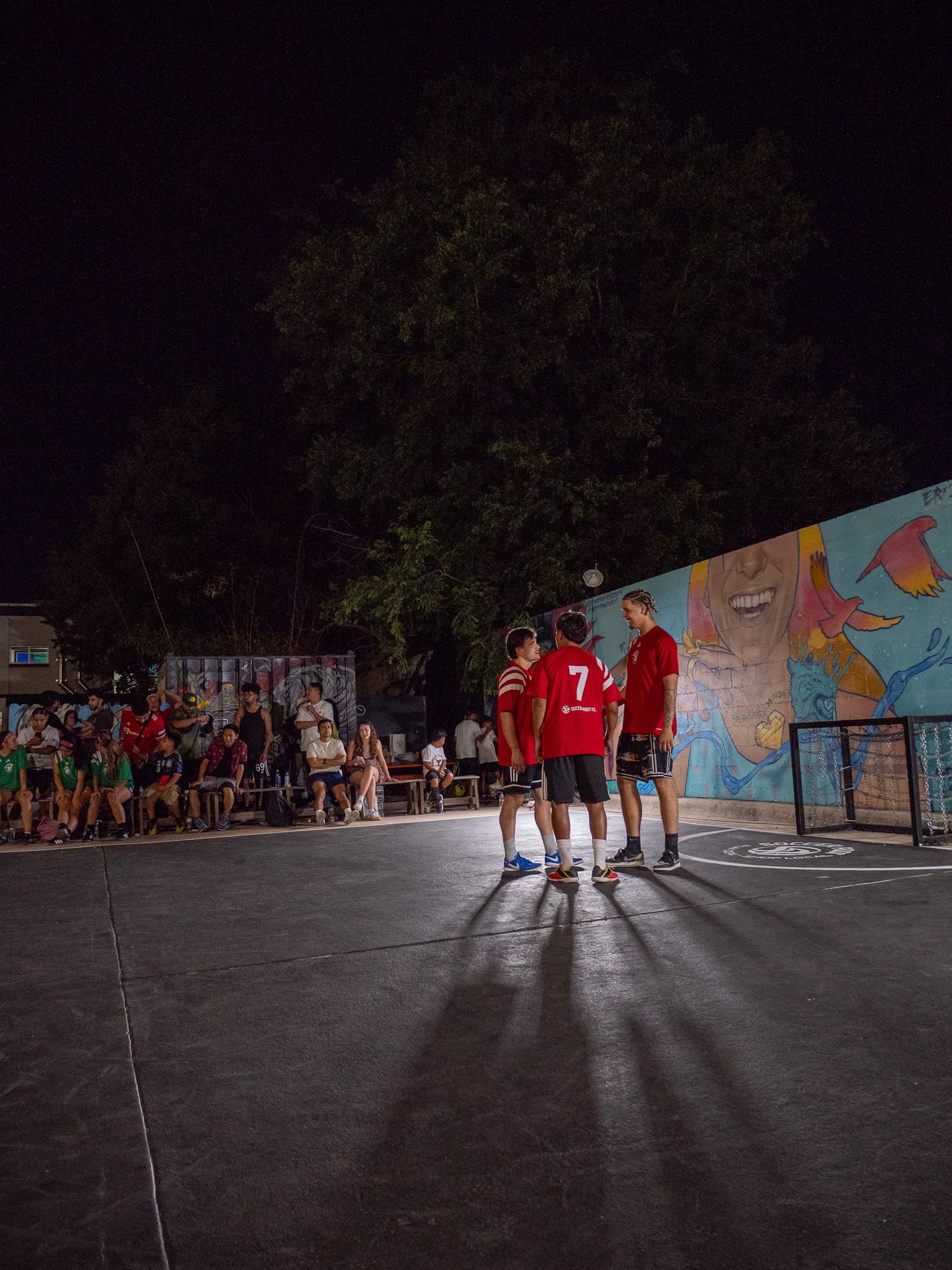 Night-time pickup match in red jerseys